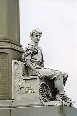 Peace, statue of mechanic holding a mallet in right hand.[15]