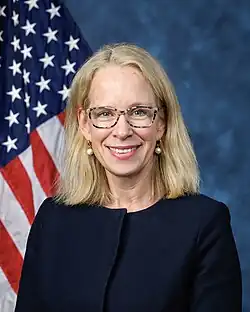 Official House portrait of Morrison smiling in front of the U.S. flag, wearing a black blazer jacket.