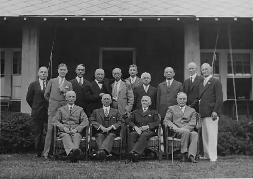 Belknap is standing farthest left in this photograph of retired U.S. Navy admirals and other retirees taken in Jamestown, Rhode Island, on 7 August 1928.