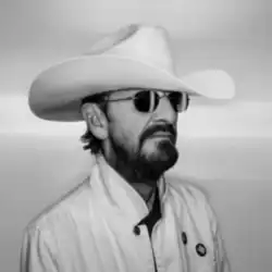 A black-and-white photo of Ringo wearing a cowboy hat and sunglasses