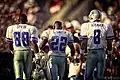 Irvin, Smith, and Aikman, photographed from behind, approach the field in their uniforms.