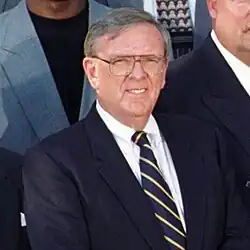 Portrait of Wolf smiling in a suit