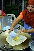 A sweet Thai roti kluai khai: similar to roti canai, it is folded around a filling of sliced bananas and eggs.