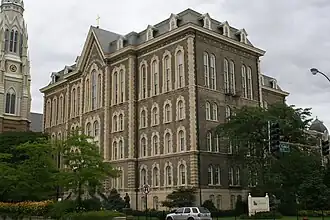 The main building of St. Ignatius College Prep in Chicago, Illinois, designed by Canadian architect Toussaint Menard, is a classic example of the style. It is one of the five extant public buildings in Chicago that predate the Great Chicago Fire of 1871.