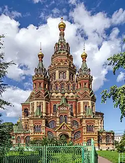 Russian Revival façade of The Cathedral of Peter and Paul with polychrome details, tented roofs and domes.