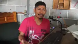 Flores Soberanes speaks into a microphone.