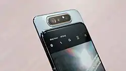 The rear camera module of Samsung Galaxy A80 rotated for selfie mode, using a combination of swivel/slider
