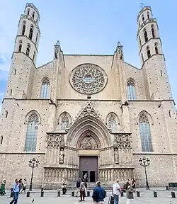 stone gothic facade with rose window and two towers
