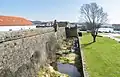 Riverside moat and walls.