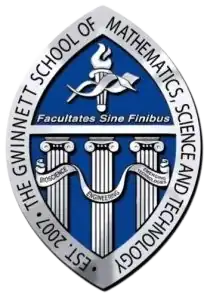 Seal of GSMST (Text around seal says "EST. 2007: THE GWINNETT SCHOOL OF MATHEMATICS, SCIENCE, AND TECHNOLOGY", text under the GCPS torch says Facultates Sine Finibus, and the text in the banners says "BIOSCIENCE ENGINEERING EMERGING TECHNOLOGIES"