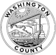 A round seal with a black-and-white depiction of a factory and the county outline