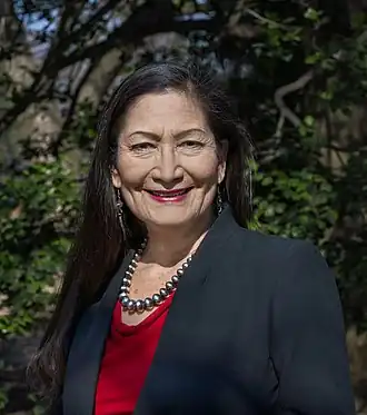 Deb Haaland is from the Laguna Pueblo people and is the first Native American Cabinet Secretary as Secretary of Interior. Her father is Norwegian-American.[66]