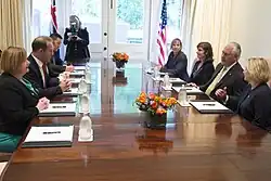 Little (as Labour leader) sitting with other politicians and officials on the left of the table, with US Secretary of State Rex Tillerson and other officials on the right of the table