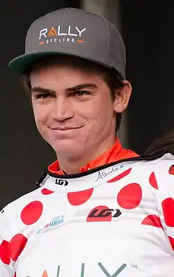 Sepp Kuss wearing red polka dot jersey and Rally Cycling hat