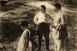 Informal photo of Stalin, his young daughter, and Sergei Kirov looking at something