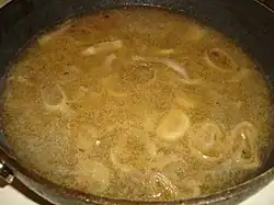 White wine sauce with shallot being cooked