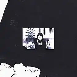 A black-and-white photo of a woman with a thick black border around it