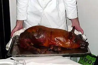 Whole roast piglet served on a tray