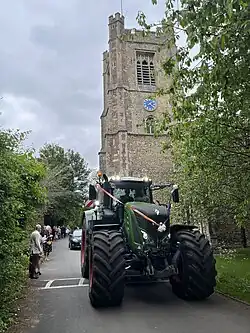St Mary's Church Tower on the occasion of a wedding in 2023. A tractor is used as the wedding car.