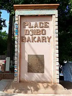 A column with a plaque below the text "PLACE DJIBO BAKARY"
