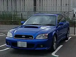 Subaru Legacy S401 STI Version, a high-performance variant of the standard Subaru Legacy sedan. This photo shows the front of the car, which is blue; there is a "S401" badge on the front grille.