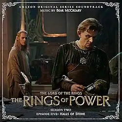 Album cover featuring a screenshot from the episode, depicting a man working at a craft table as another man watches him in the background.