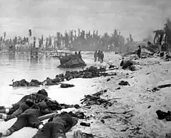 View of the beach of Betio Island, filled with dead marines and a destroyed Sherman tank, Tarawa