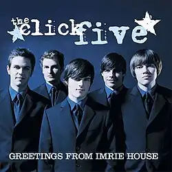 The cover features the band wearing suits against a blue background. The band's logo appears above them and the album title is below them, colored in white.
