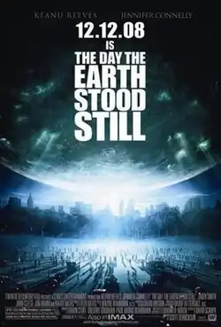 A large crowd of people look up at the sky to see a glowing planet approach them, with the poster's text reading "12.12.08 IS THE DAY THE EARTH STOOD STILL".
