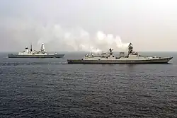 INS Kolkata and HMS Defender during an exercise.