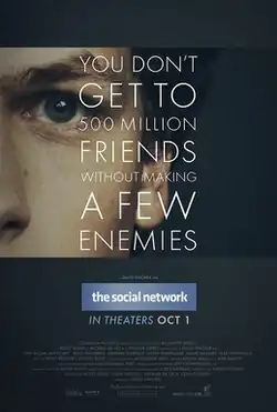 On top of a man's face, in white font, the phrase "You Don't Get to 500 Million Friends Without Making a Few Enemies" appears, covering most of the poster. Underneath, the words "The Social Network" are presented in a Facebook-esque style and logo.