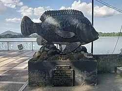 Large statue of a fish on a rectangular plinth