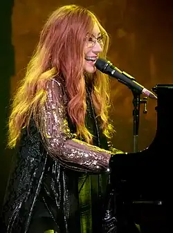 Amos performing in 2017