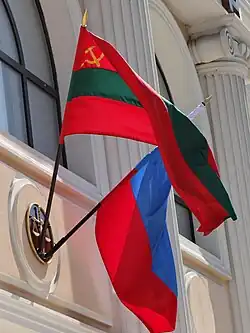 The Transnistrian state flag and Russian flag on the facade of a court building in Tiraspol, the capital of Transnistria