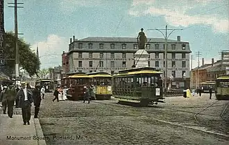 A 1909 view of Monument Square, with the former United States Hotel behind the Soldiers' and Sailors' Monument, itself behind a Portland Railroad Company trolleycar