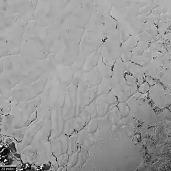 Close-up photograph (context) showing polygonal convection cells in the nitrogen ice of Sputnik Planitia, the western lobe of Tombaugh Regio (14 July 2015).