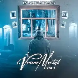 A person in a hoodie sitting down and staring towards a window, which is surrounded by pictures on a wall.