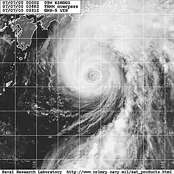 Satellite image of a weakening typhoon south of Japan. The storm's eye is mostly cloud-filled and cloud cover is mostly extending to the north of the center.