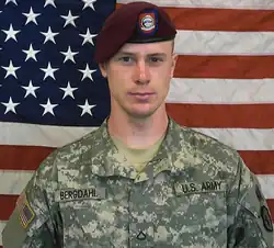 Headshot of a uniformed Bergdahl in front of an American flag
