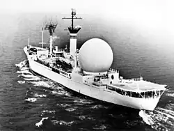 USNS Kingsport underway on 29 January 1963. The photo shows the 53-foot (16 m) white plastic dome that protects the 30-foot (9.1 m) stabilized parabolic antenna.