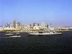 Tripoli leads a ship parade followed by landing craft in San Diego Bay