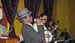 "Uncle" Lionel Batiste (in derby hat) with "Papa" Don Vappie (with banjo)