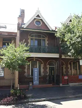 Vermont Terrace, Millers Point (1891). An early, fairly groundbreaking terrace-pair, with polychrome brick and rounded windows. Possibly designed by Morell & Kemp.[176][177]