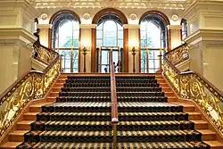 View of a stair in the Palace Hotel's lobby, formerly the center wing of the Villard Houses. The staircase leads up to a set of three arches that formed the entrances to 453 and 455 Madison Avenue.