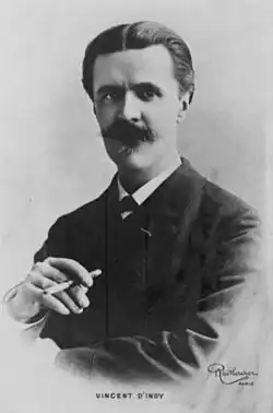 Head and upper body portrait of a middle-aged man with dark hair and heavy moustache, holding a cigarette in his right hand