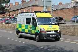 An NHS ambulance in England, marked with Star of Life and the local ambulance service emblem