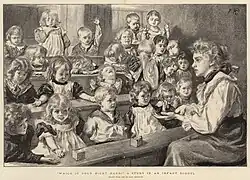 A teacher sits in front of a number of children, many of whom do not appear very attentive.