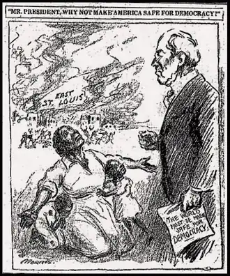 An African American woman on her knees, begging President Wilson. Wilson is holding a newspaper with a headline that says "The world must be made safe for democracy"