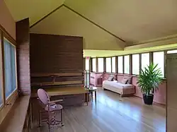 Johnson's daughter's bedroom, a narrow space with a sloped ceiling and windows to the left and right