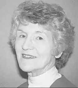 caucasian female with curled hair, looking sideways